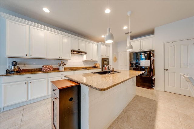 kitchen with visible vents, backsplash, a sink, an island with sink, and black appliances