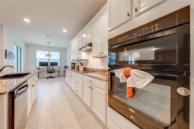 kitchen with light tile patterned floors, under cabinet range hood, a sink, visible vents, and black appliances