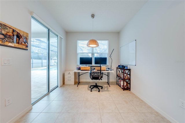 office area featuring baseboards and light tile patterned flooring