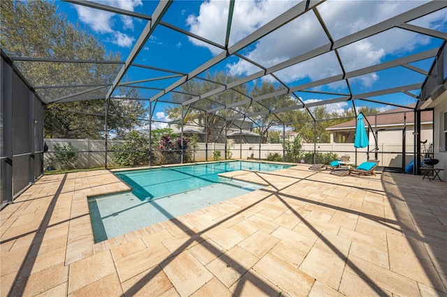 view of pool with a fenced in pool, glass enclosure, a fenced backyard, and a patio