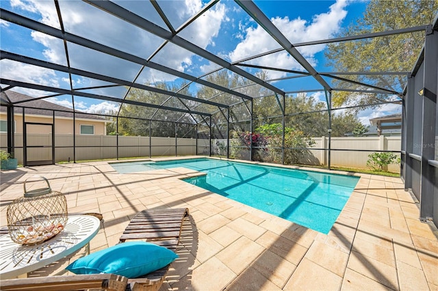 view of swimming pool with a patio area, a fenced backyard, glass enclosure, and a fenced in pool