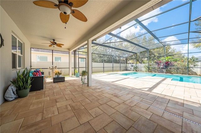 view of pool featuring glass enclosure, a fenced backyard, a fenced in pool, and a patio