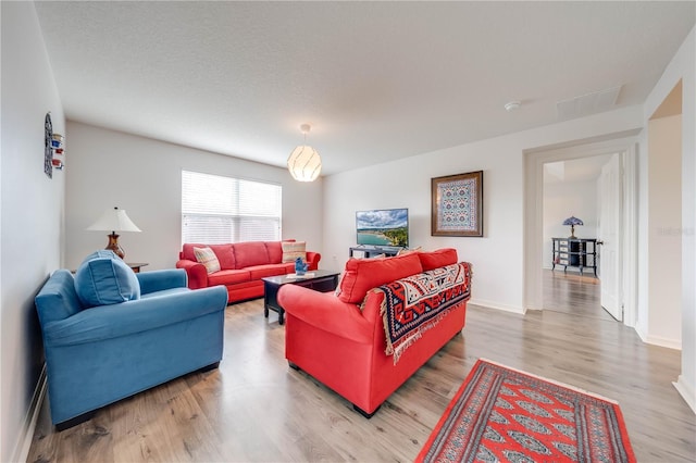 living area with light wood finished floors and baseboards