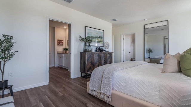 bedroom featuring visible vents, connected bathroom, baseboards, and dark wood-type flooring