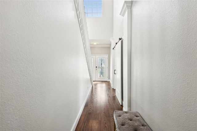 hallway with dark wood finished floors and baseboards