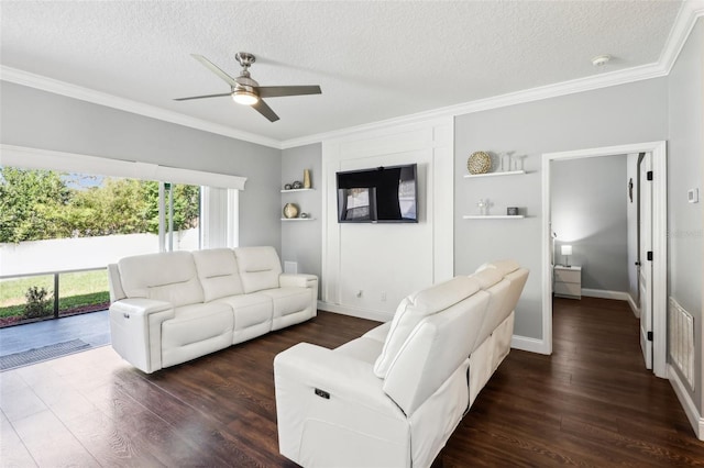 living room featuring dark wood-type flooring, ornamental molding, and a textured ceiling