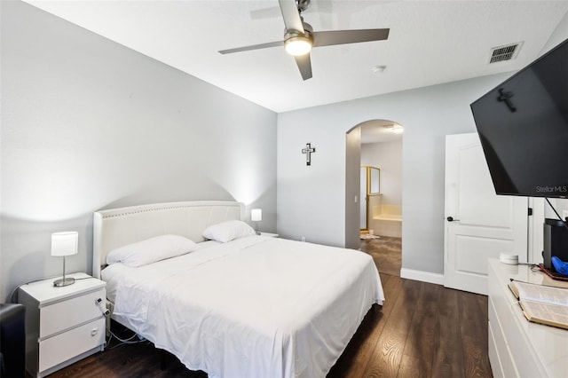 bedroom featuring visible vents, arched walkways, a ceiling fan, dark wood-style flooring, and ensuite bathroom