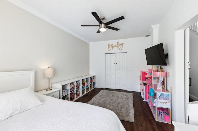 bedroom with ceiling fan, a closet, baseboards, and dark wood-style flooring