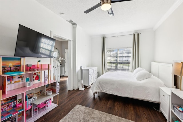 bedroom with dark wood-type flooring, visible vents, a textured ceiling, and a ceiling fan