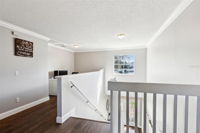 staircase with baseboards, a textured ceiling, ornamental molding, and wood finished floors