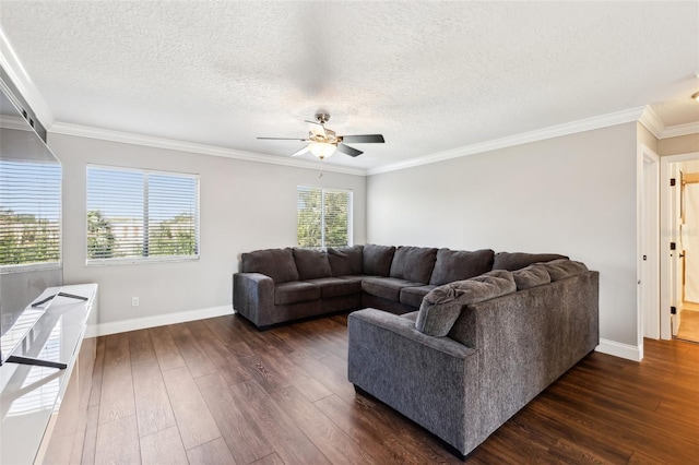 living area featuring dark wood-type flooring, crown molding, baseboards, and ceiling fan