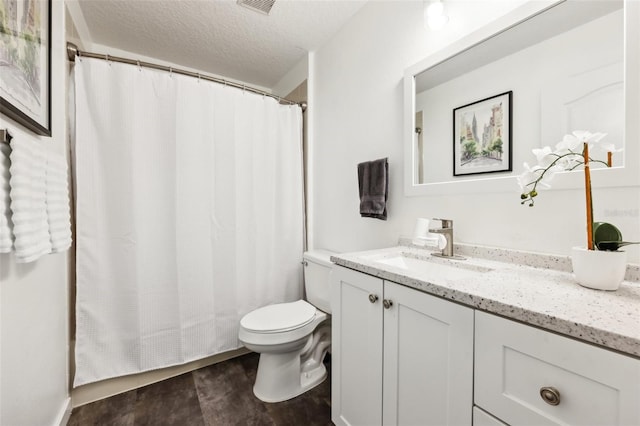 full bathroom with visible vents, toilet, vanity, and a textured ceiling