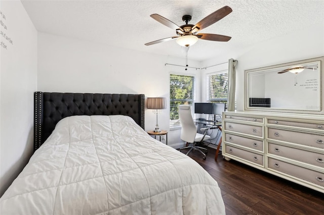 bedroom with dark wood-type flooring, ceiling fan, and a textured ceiling