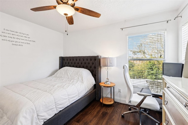 bedroom with baseboards, a ceiling fan, and dark wood-style flooring