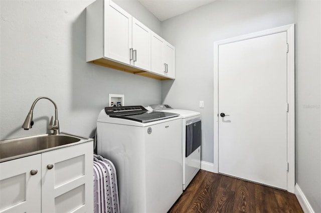 laundry room featuring cabinet space, baseboards, dark wood-style flooring, independent washer and dryer, and a sink