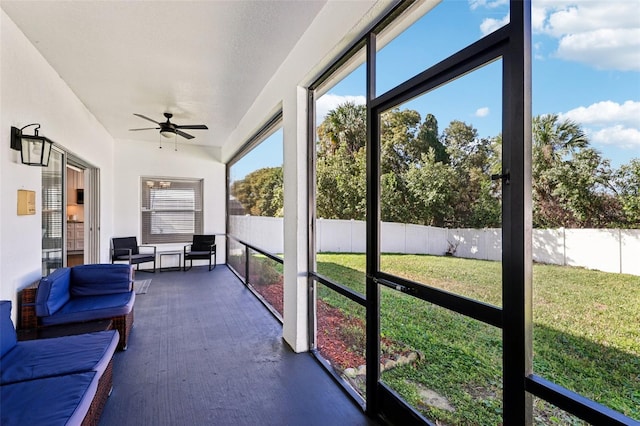 sunroom featuring ceiling fan