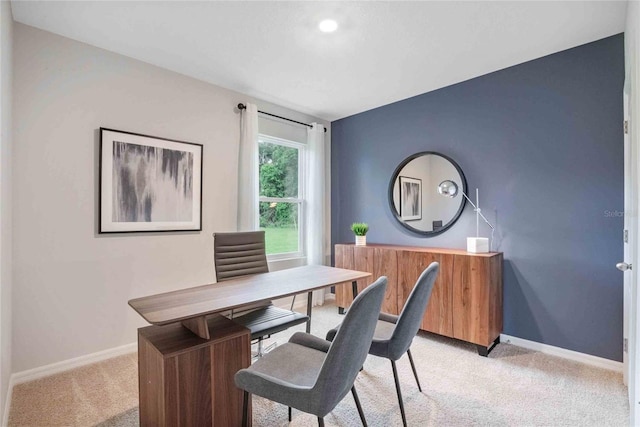 office space with baseboards and light colored carpet