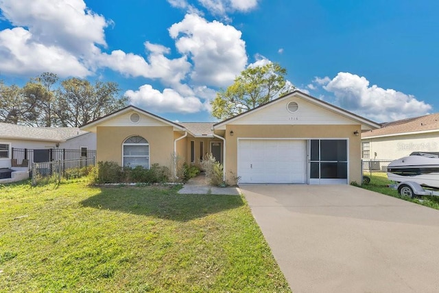 ranch-style home featuring concrete driveway, an attached garage, fence, a front yard, and stucco siding