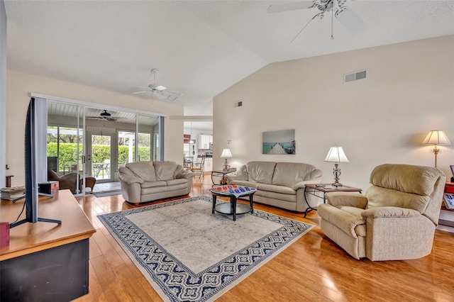 living room with visible vents, vaulted ceiling, hardwood / wood-style floors, and ceiling fan