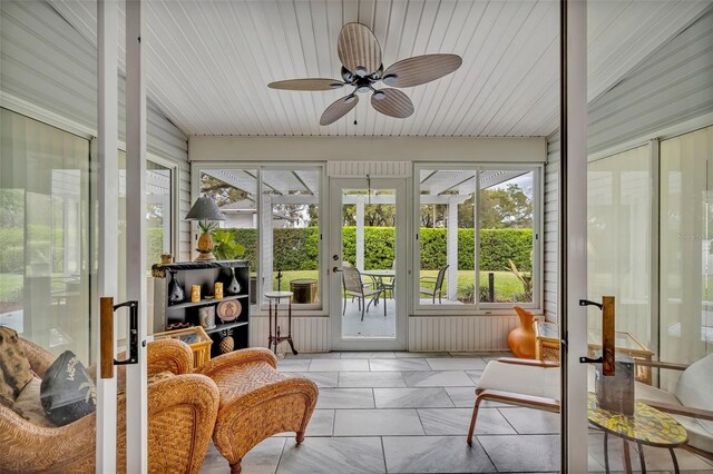 sunroom / solarium with ceiling fan and plenty of natural light