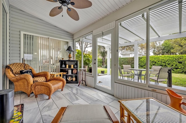 sunroom / solarium featuring a wealth of natural light, vaulted ceiling, and ceiling fan