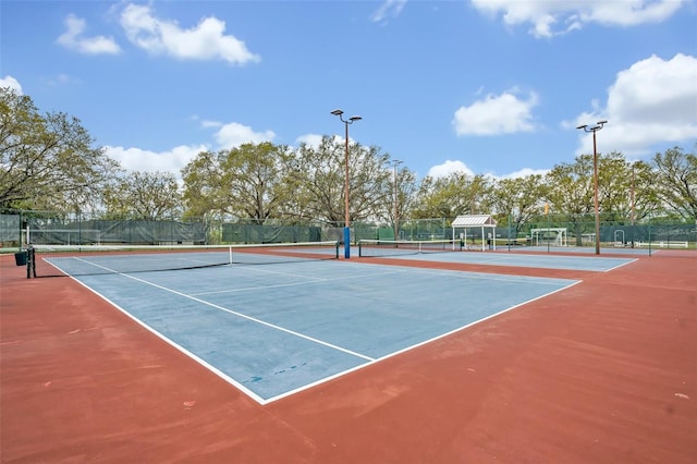 view of sport court featuring fence