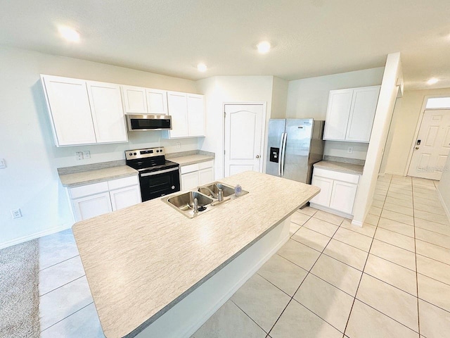 kitchen featuring stainless steel appliances, light countertops, a kitchen island with sink, white cabinets, and a sink