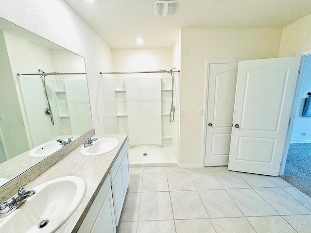 full bath with a sink, visible vents, and tile patterned floors