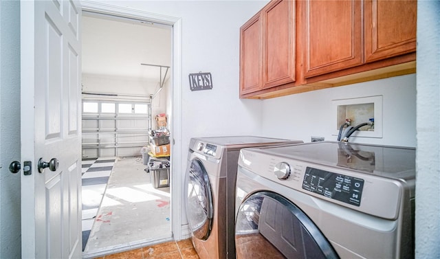 laundry area with a garage, cabinet space, and washer and clothes dryer