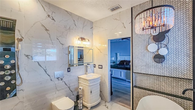 bathroom with marble finish floor, visible vents, toilet, a textured ceiling, and vanity