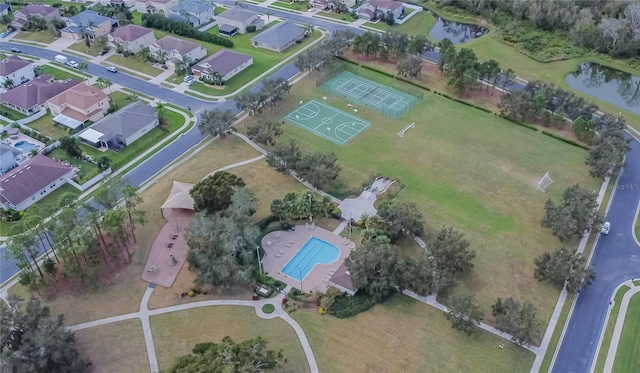 birds eye view of property with a water view and a residential view