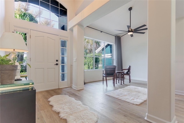 entryway with a ceiling fan, baseboards, and wood finished floors