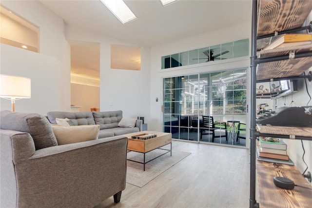 living room with high vaulted ceiling and wood finished floors