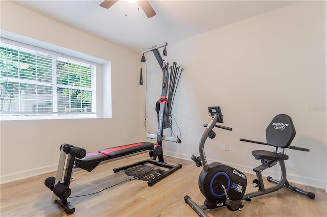 exercise room with ceiling fan, wood finished floors, and baseboards