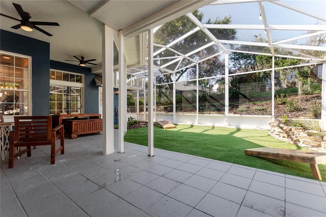 view of patio featuring a lanai and ceiling fan