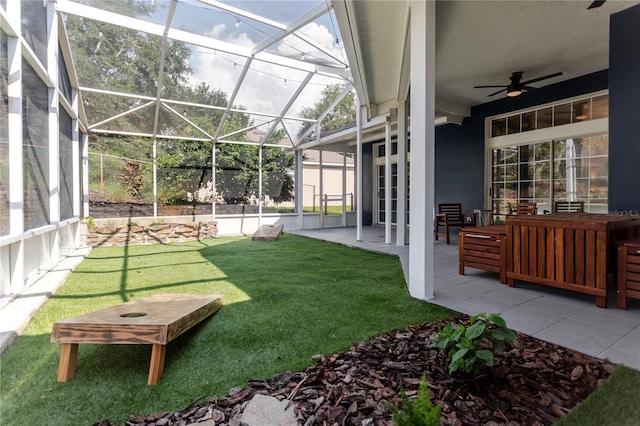 view of yard with a patio area, a lanai, and a ceiling fan