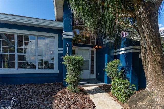 doorway to property with stucco siding