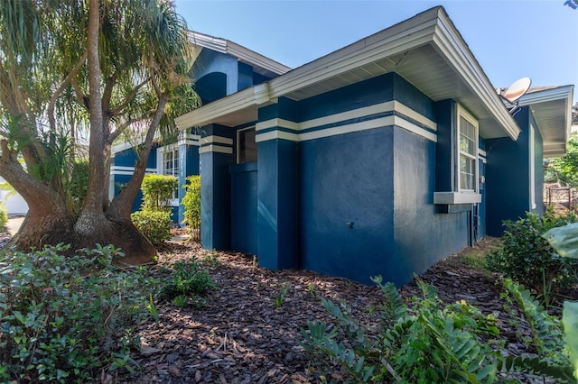 view of side of property with stucco siding