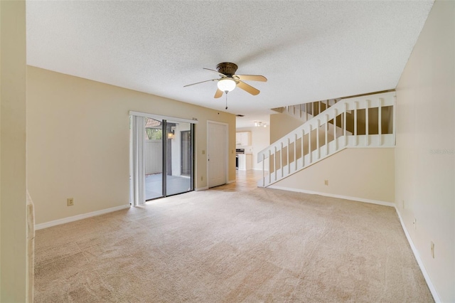 unfurnished room featuring light carpet, stairway, and baseboards