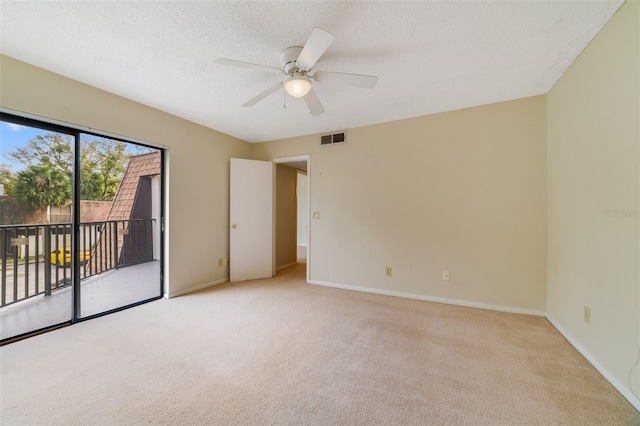 unfurnished room featuring light colored carpet, visible vents, a textured ceiling, and baseboards