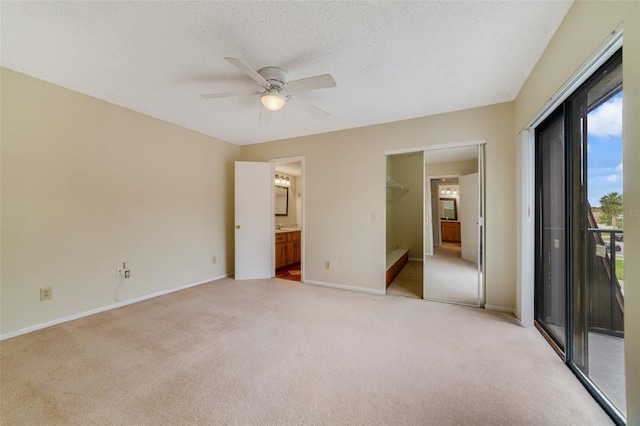 unfurnished bedroom featuring a textured ceiling, ceiling fan, light colored carpet, baseboards, and access to outside