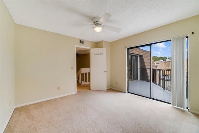 unfurnished bedroom with light carpet, baseboards, visible vents, access to exterior, and a textured ceiling