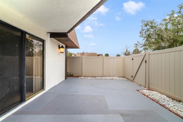 view of patio featuring a fenced backyard and a gate