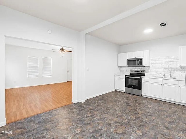 kitchen featuring stainless steel appliances, white cabinets, light countertops, and visible vents