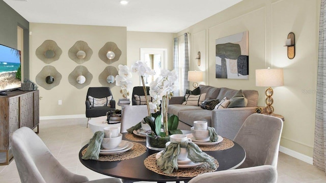 dining room featuring baseboards and light tile patterned floors