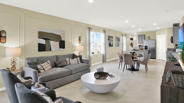 living area with recessed lighting and baseboards