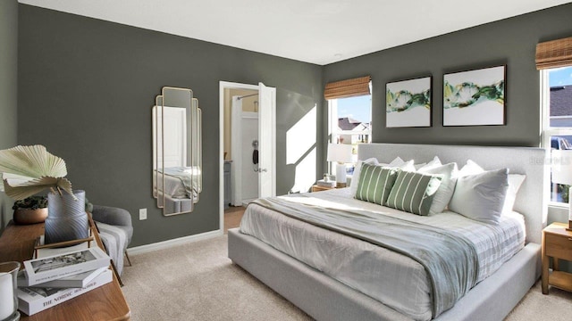 bedroom with light carpet, baseboards, and multiple windows