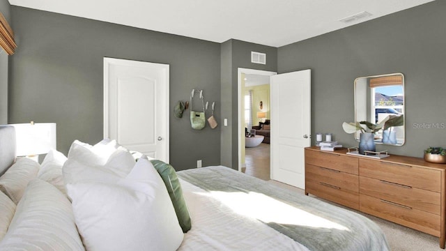 bedroom with visible vents and light colored carpet