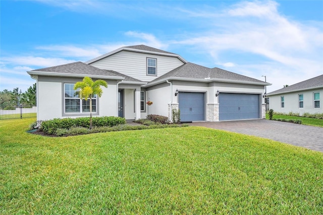 traditional home featuring decorative driveway, roof with shingles, stucco siding, an attached garage, and a front lawn