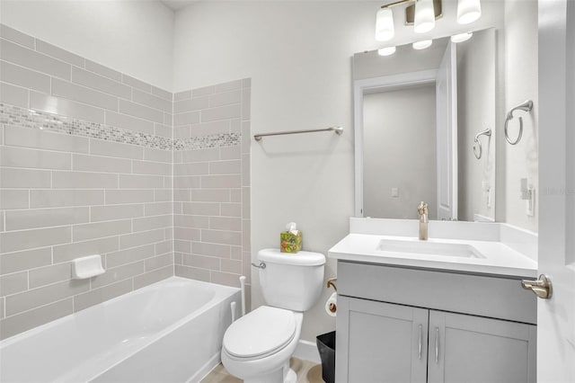 bathroom with shower / tub combination, vanity, and toilet